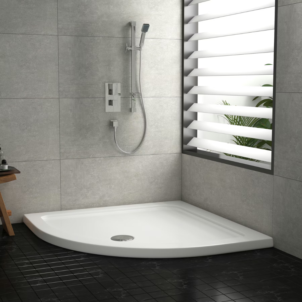 Curved quadrant shower base with grey tiles, vertical shower system, slatted window, and indoor plant