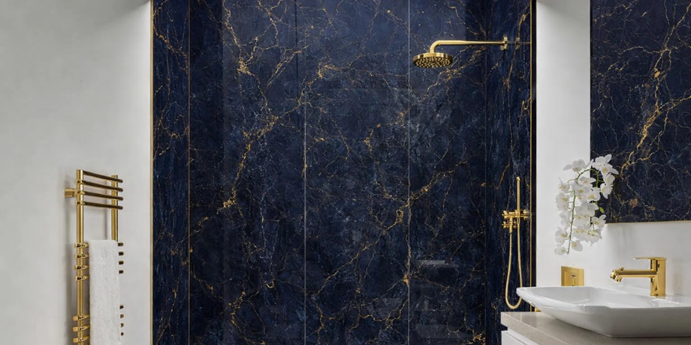 Bathroom with blue marble-effect PVC panels and gold fittings including rainfall shower and tap.