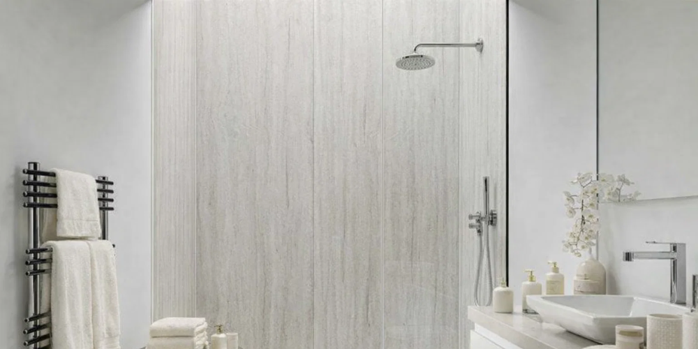 Bathroom with beige wall panels, rainfall showerhead, white fittings, and black towel rail.