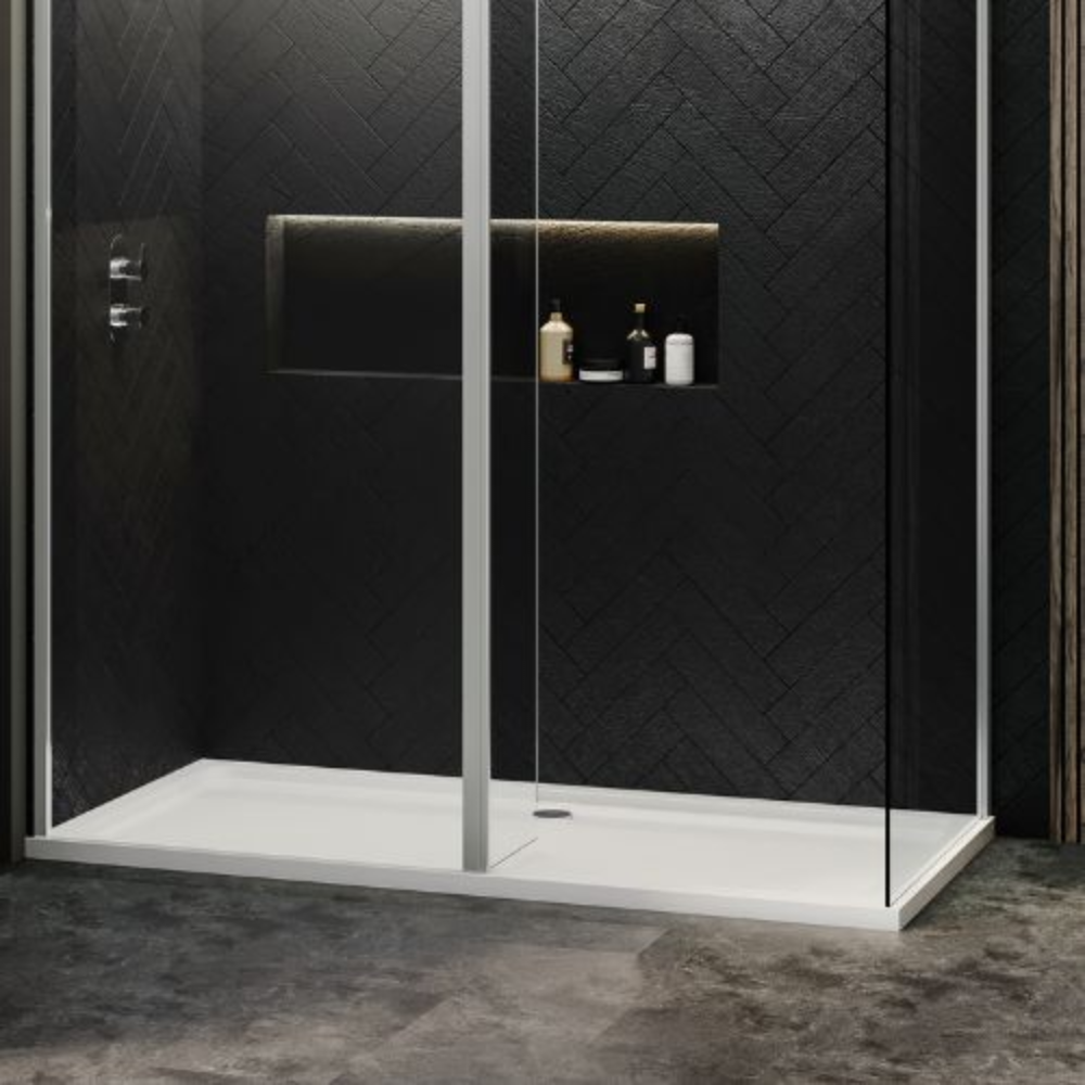 Shower with sleek glass doors, dark herringbone tile walls, and recessed storage with toiletries